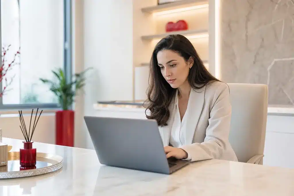 facelift surgeons content marketing strategy: a writer working at a laptop in a bright office draf