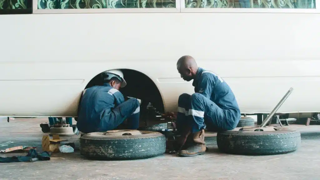 Collision Repair PPC Agency Photo A Collision Repair Google Ads Agency: technicians servicing a vehicle wheel and suspension