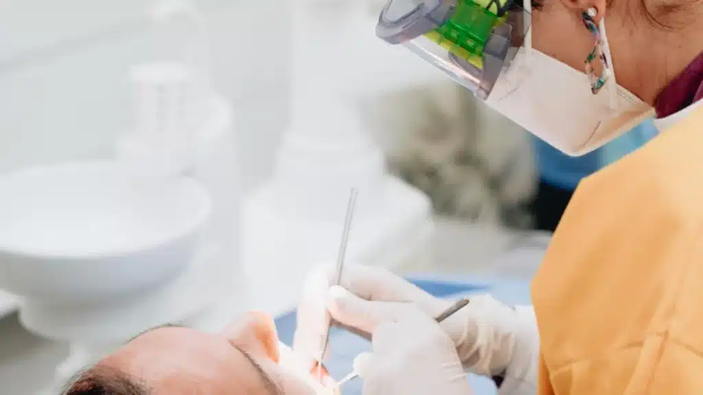 DSO Lead Generation Agency Photo A DSO Patient Lead Generation Agency: dentist providing a clinical dental procedure