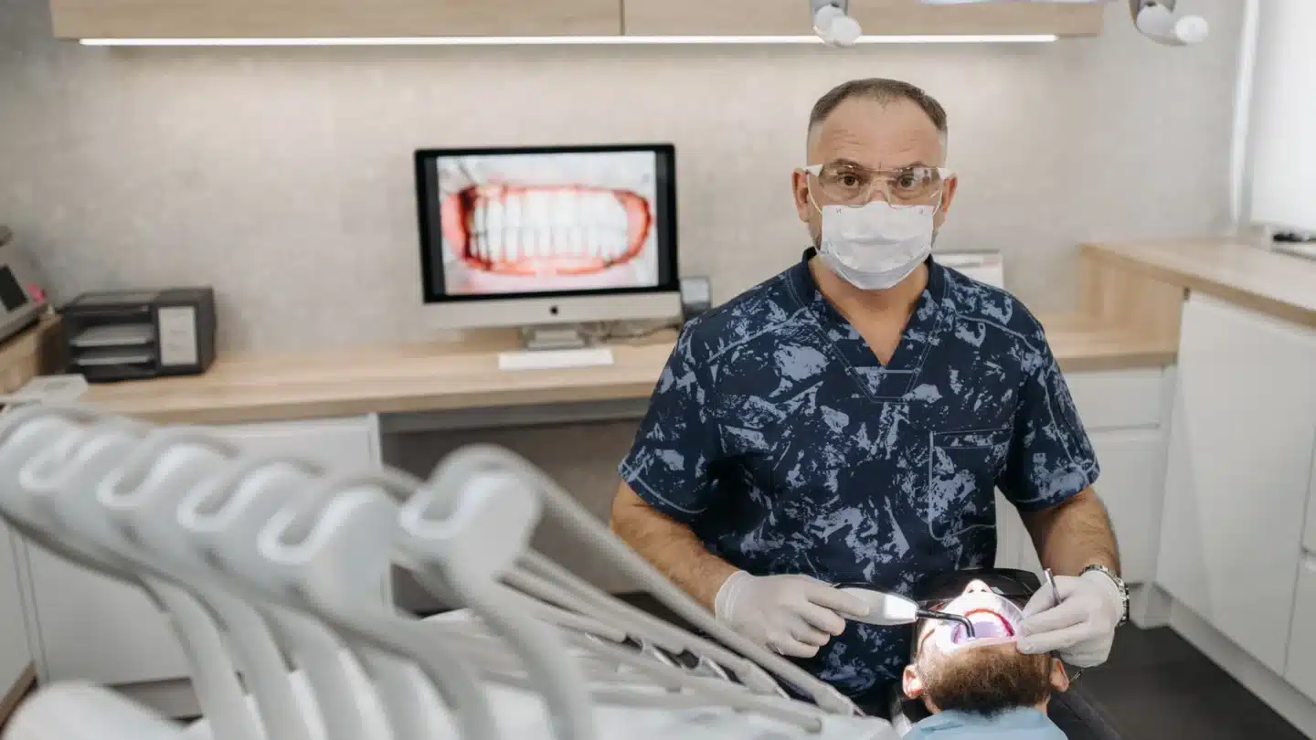 DSO Lead Generation Agency Hero DSO Lead Generation Agency: dentist examining a patient with clinical technology