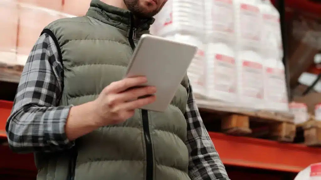 B2B Ecommerce AEO Agency: warehouse employee using a tablet for inventory