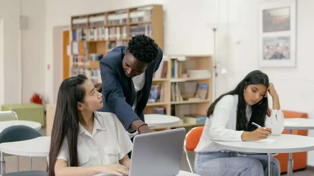Career College and Trade School GEO Agency: instructor guiding a student using a laptop