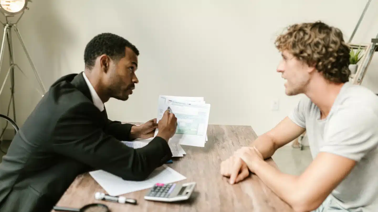 Financial Services and Wealth Management Marketing Agency Hero Financial Services and Wealth Management Marketing Agency: financial advisor reviewing documents with a client