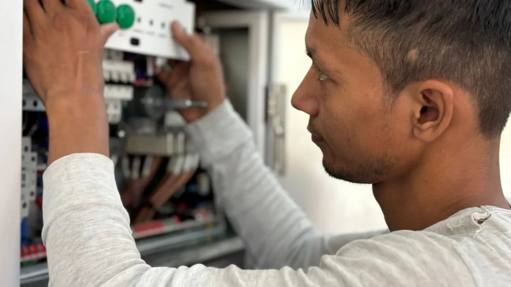 Electrical Contractors PPC Agency Photo B Electrical Contractors Paid Search Agency: electrician adjusting circuit breakers