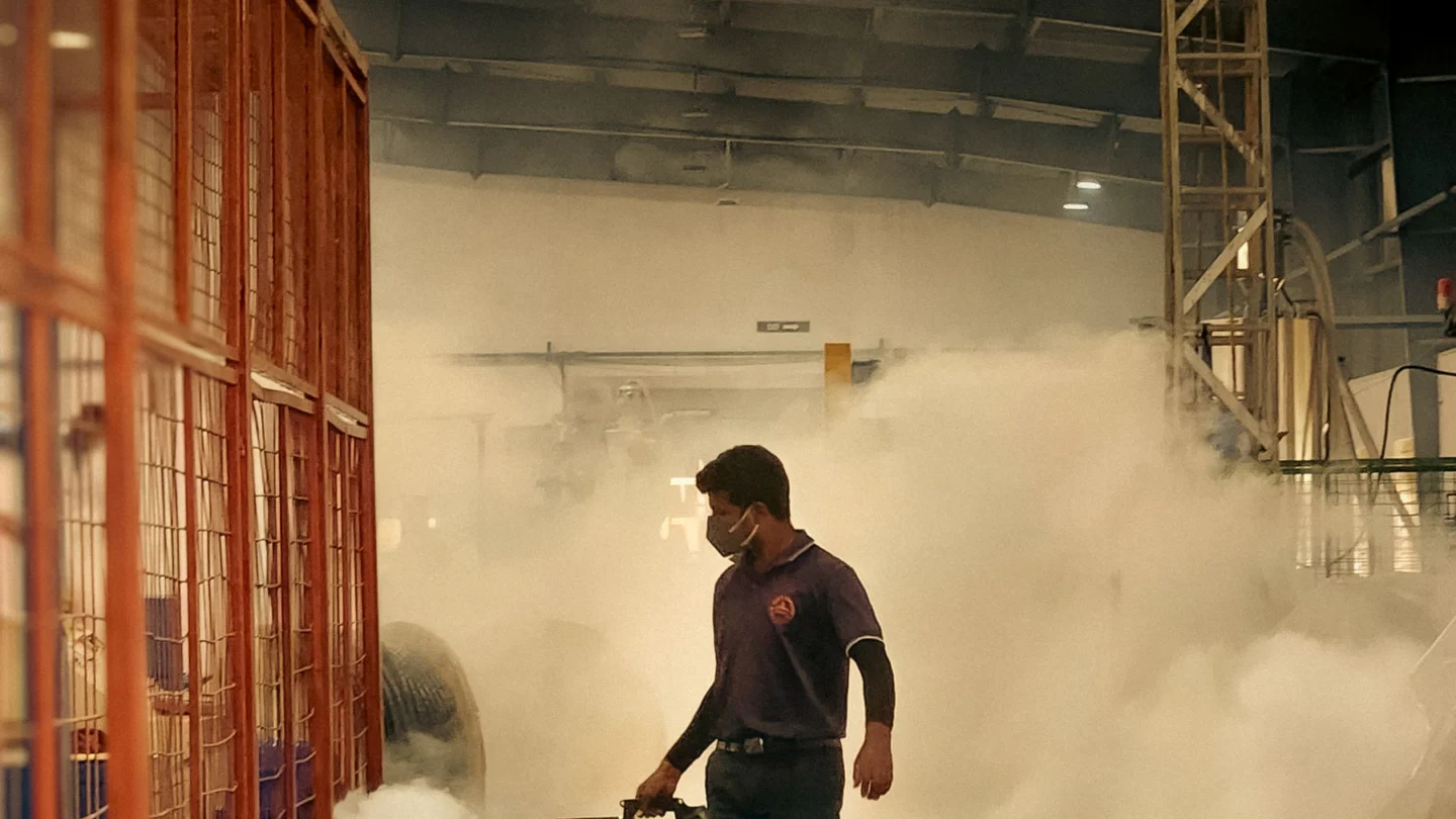 Pest Control Marketing Agency Hero Pest Control Marketing Agency: worker fogging an industrial warehouse for pest control