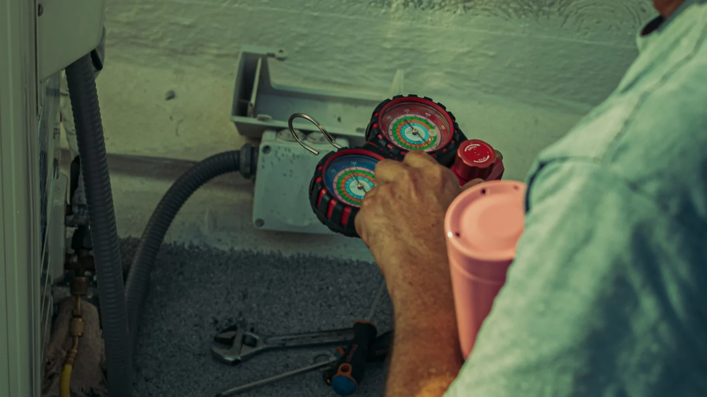 Roofing Digital Marketing Agency: service technician working with HVAC gauges and tools