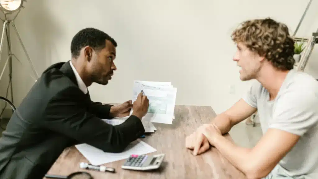 Medicare and Health Insurance Digital Marketing Agency Photo A Medicare and Health Insurance Digital Marketing Company: agent reviewing financial and policy documents with a client