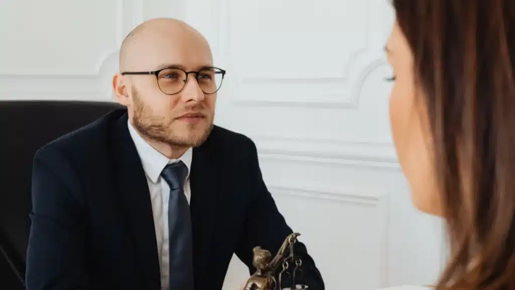 Medical Malpractice Law Lead Generation Agency Photo B Medical Malpractice Law Consultation Conversion Agency: attorney speaking with clients beside legal materials