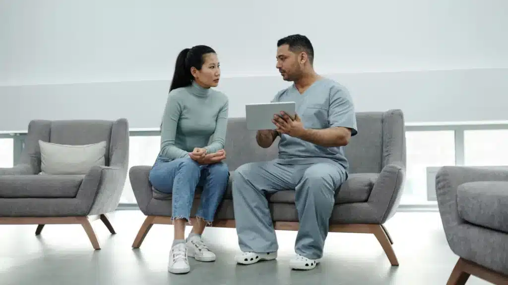 Specialty Medical Practice Digital Marketing Company: doctor discussing care with a patient using a tablet