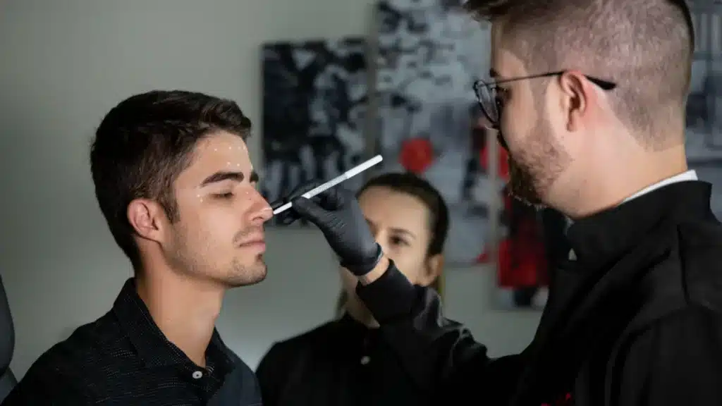 Plastic Surgery and Aesthetic Medicine Digital Marketing Company: plastic surgeon carefully marking a patient face during pre-procedure planning in a cl...
