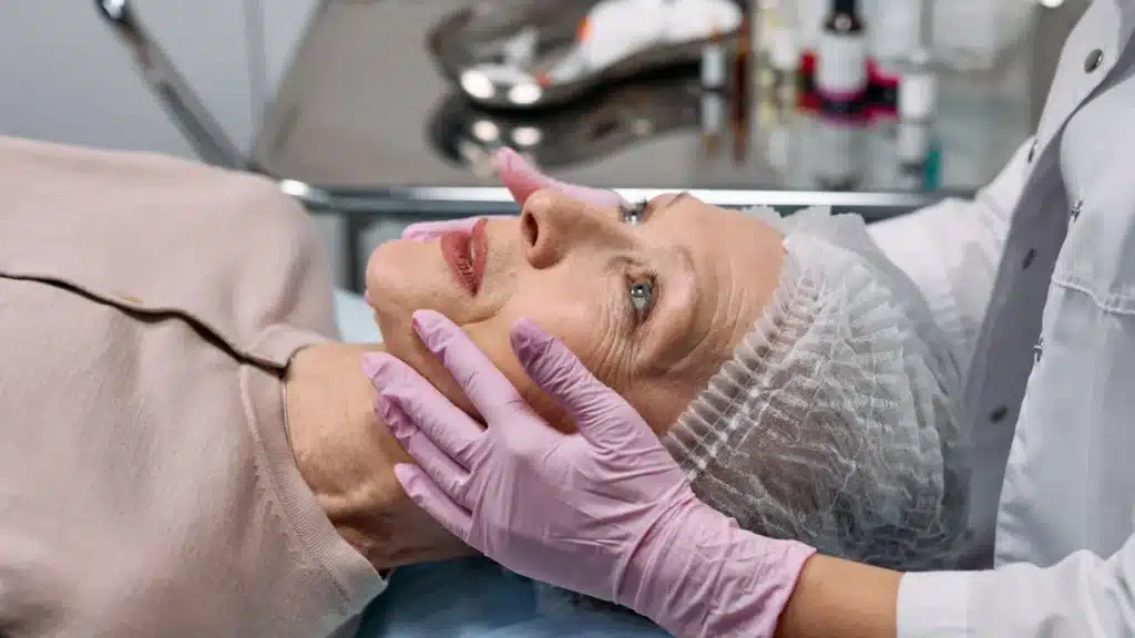 Rhinoplasty Marketing Company: medical professional examining a patient face during a cosmetic surgery consultation