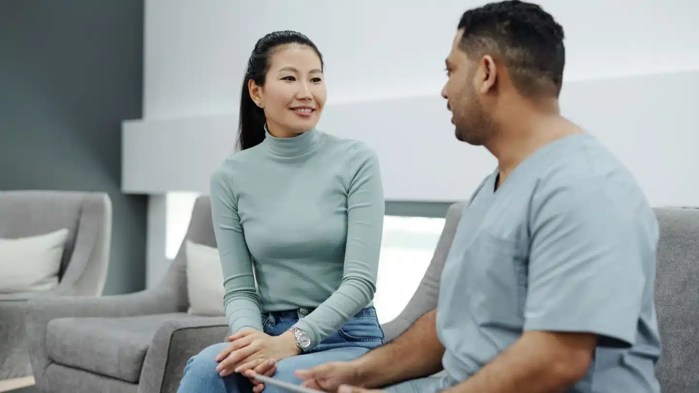 Rhinoplasty Lead Generation Agency Hero Rhinoplasty Lead Generation Agency: doctor and prospective patient discussing care and next steps with a tablet in a modern clinic