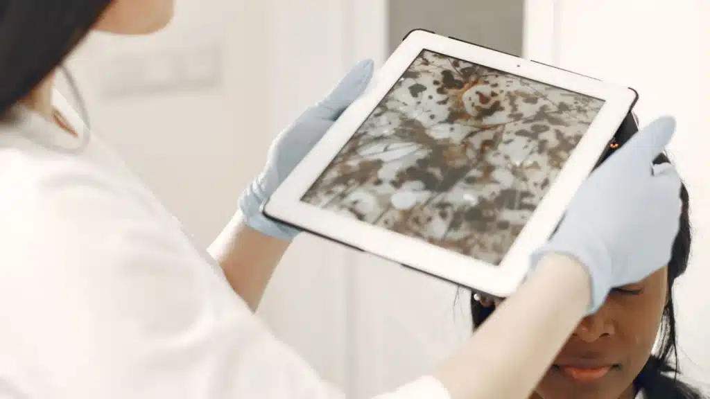 Rhinoplasty AEO Agency: medical professional reviewing a patient facial treatment plan with a tablet during a consultation
