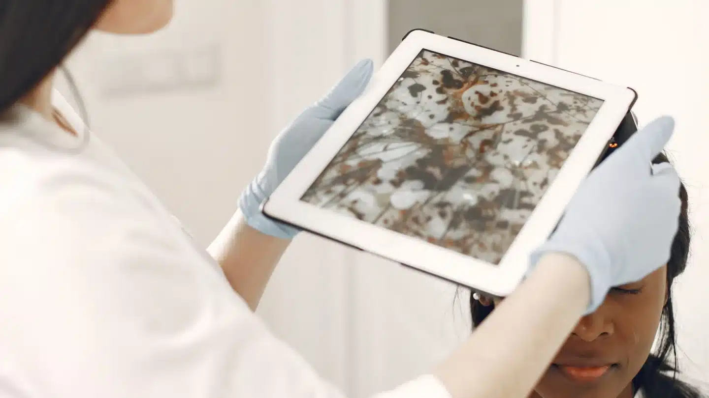 Rhinoplasty Digital Marketing Agency: medical professional reviewing a patient facial treatment plan with a tablet during a consultation