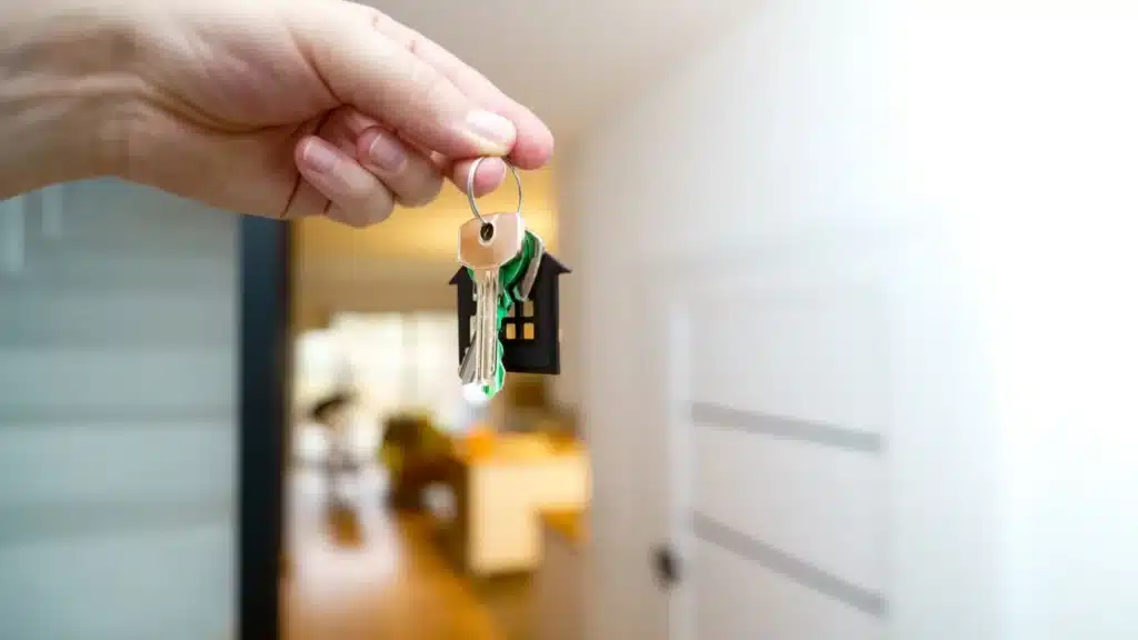 Real Estate and Property Management SEO Agency: real estate professional holding keys to a new property