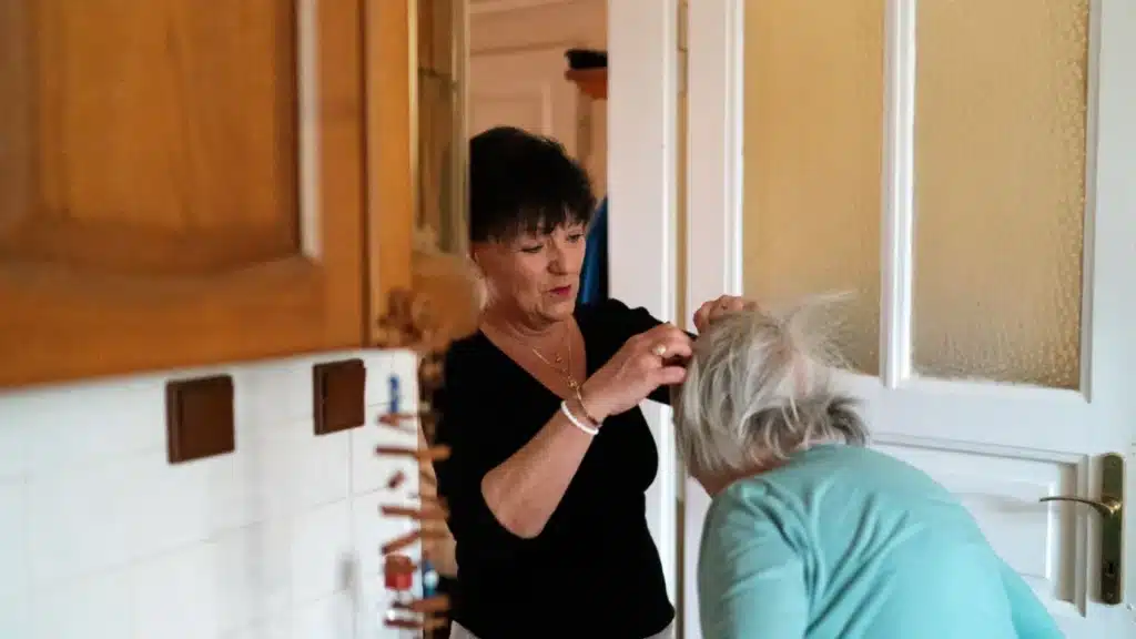 Assisted Living SEO Agency Photo A Assisted Living SEO Company: caregiver assisting an elderly woman with grooming