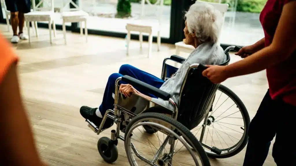Senior Living Home Care and Hospice Marketing Agency Photo A Senior Living, Home Care and Hospice Digital Marketing Company: caregiver supporting a senior in a nursing home