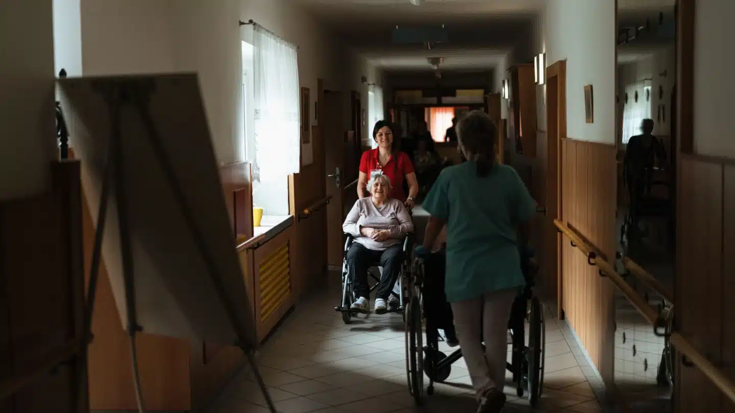 Senior Living Home Care and Hospice Marketing Agency Hero Senior Living, Home Care and Hospice Marketing Agency: caregiver assisting seniors in a retirement community