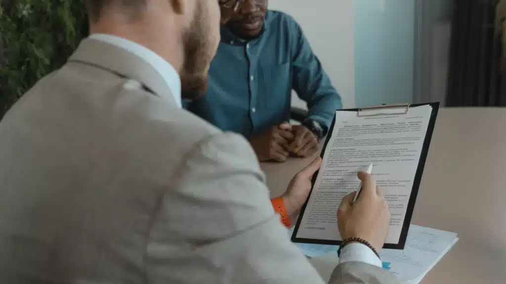 Staffing and Recruiting Marketing Agency Photo A Staffing and Recruiting Digital Marketing Company: recruiter reviewing a candidate contract and resume