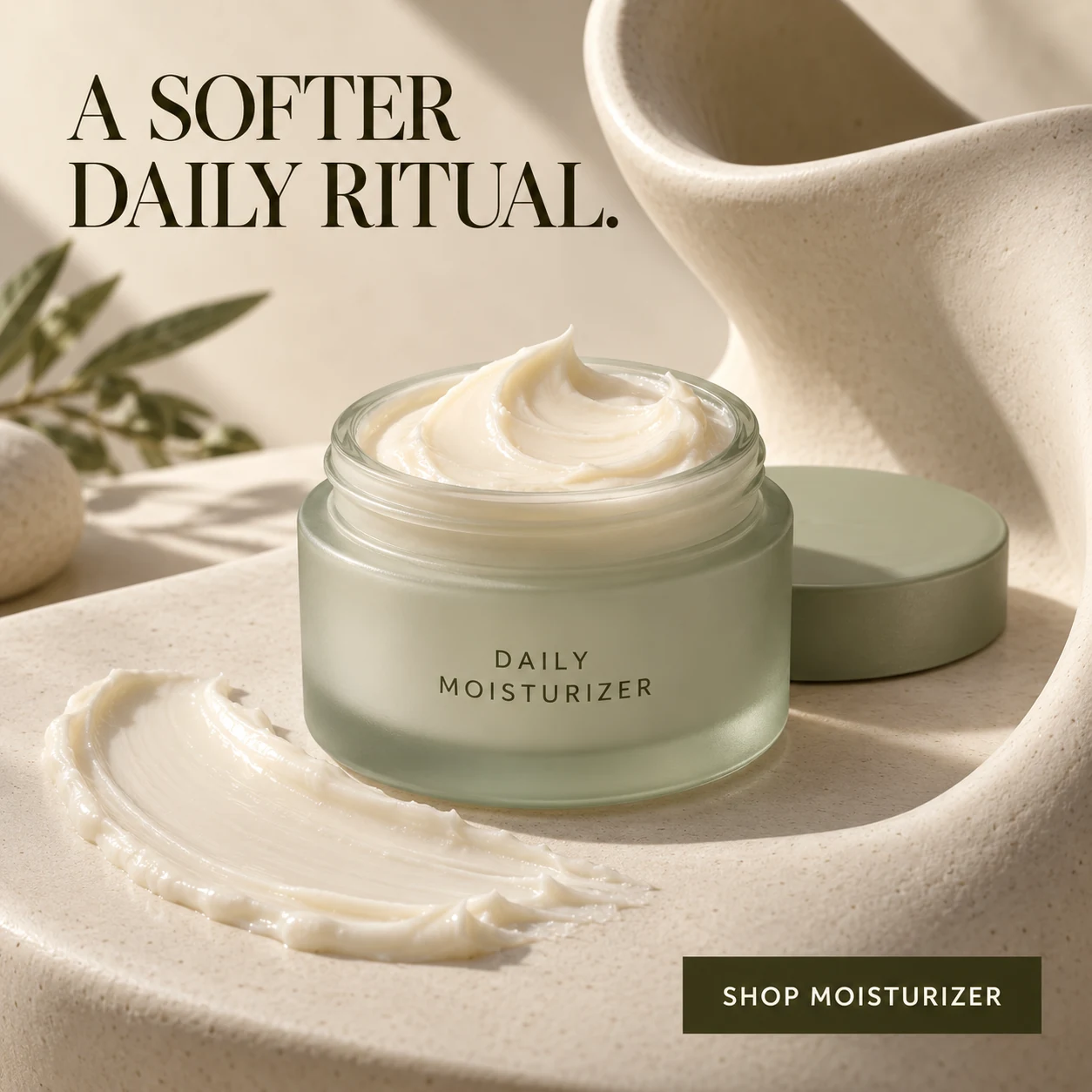 Skincare advertisement with an open pale sage moisturizer jar and tactile cream on a sculptural ivory porcelain set, under the headline A SOFTER DAILY RITUAL.