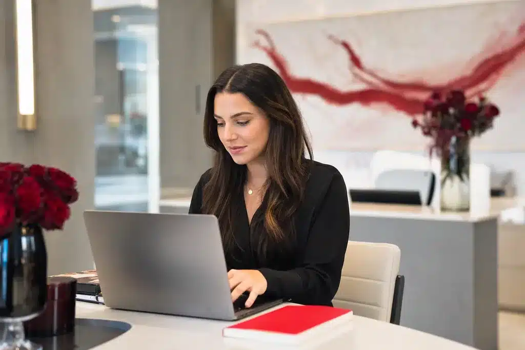 rhinoplasty practices content marketing strategy: a writer working at a laptop in a bright office draf